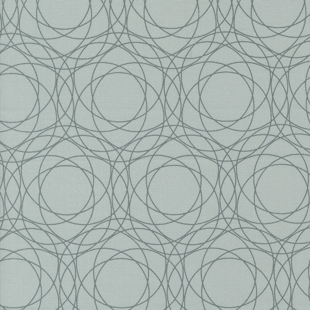 Shimmer by Zen Chic for Moda. Silver- Geometric Medium Gray Circles on a Light Gray Background.