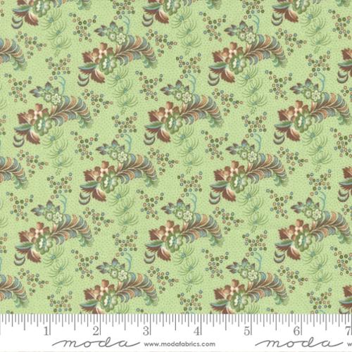 Repeating floral pattern done in shades of brown and green on a light green background. Florals are similar to a Fleur Di Lis style. Fabric