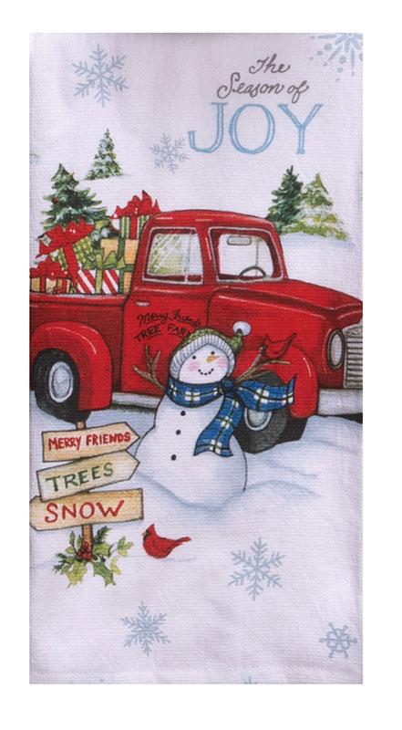 A terry towel with a holiday design of a bright red truck filled with presents and a smiling snowman. The words "The Season of Joy" are printed on the top part of the towel.