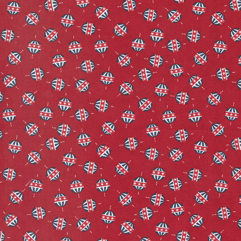 Red, White and Blue Circle/Star Design on a Red Background. The design looks like a bouncy ball or top. Fabric