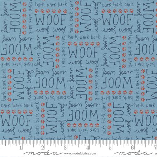 The words "Woof" and "Bark" printed in different fonts highlighted with little red paw prints on a light blue background. Fabric