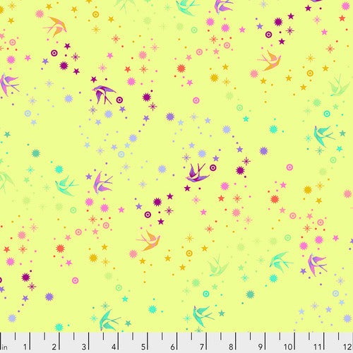 Lime green background with a rainbow print on top of dots, stars, and birds. Fabric