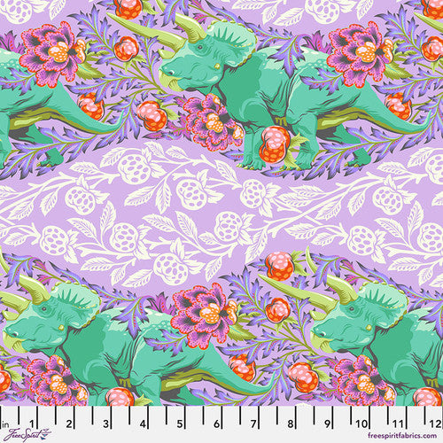 ROAR! by Tula Pink for FreeSpirit Fabrics. Trifecta - Mist: Teal Triceratops Surrounded by Traditional Flowers and Patterns in Peaches, Pinks, and Purples on a Light Purple Background.